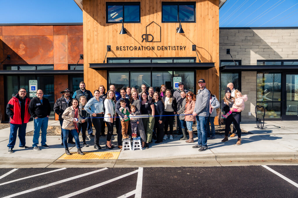 Guests gather in front of the Restoration Dentistry building, located in Meridian, ID, for their ribbon cutting ceremony.